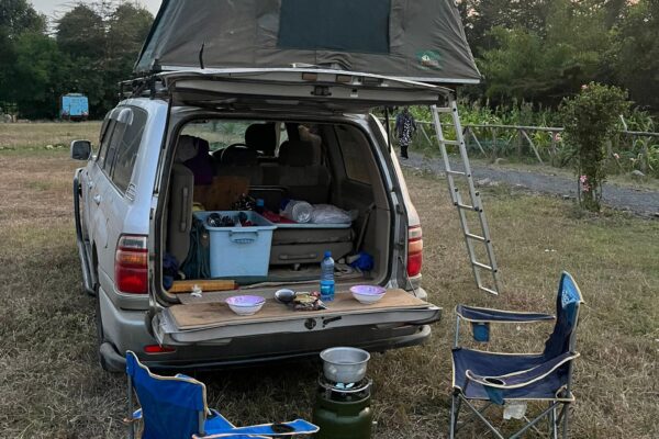 Land cruiser with rooftop tent with camping gear